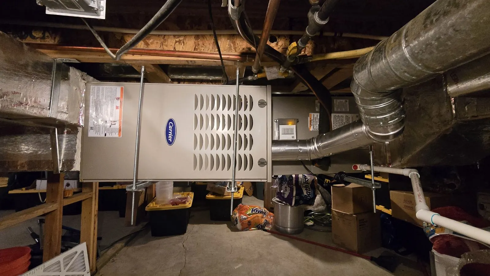 Horizontal furnace installed between basement ceiling joists
