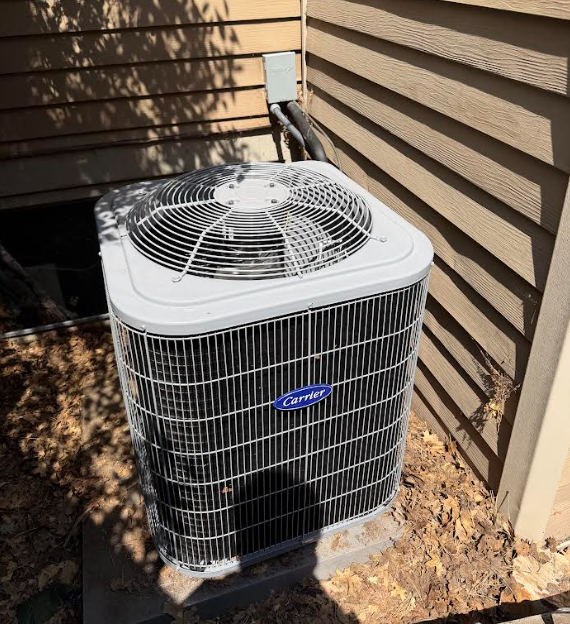 Carrier residential outdoor air conditioning unit ready for seasonal tune-up and maintenance