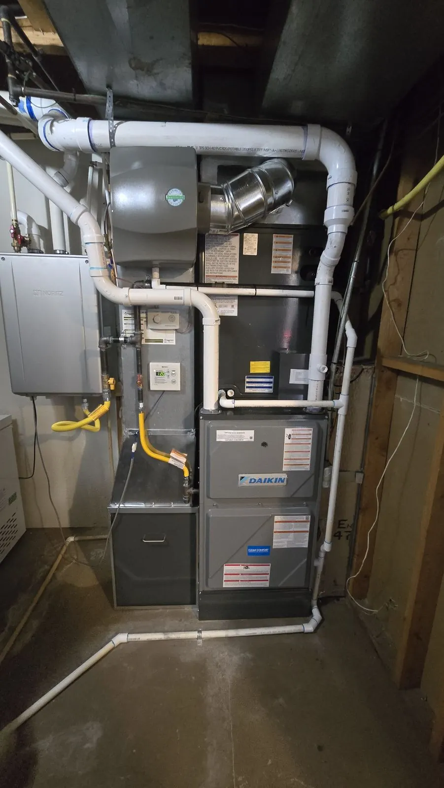 New Daikin high-efficiency gas furnace installed with PVC venting in a utility room