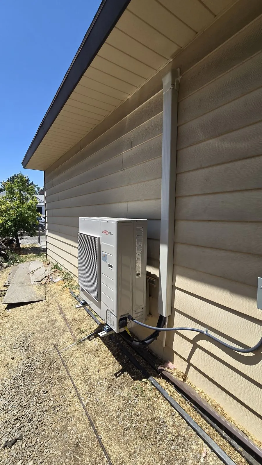 Outdoor heat pump unit installed beside a Northern Utah home